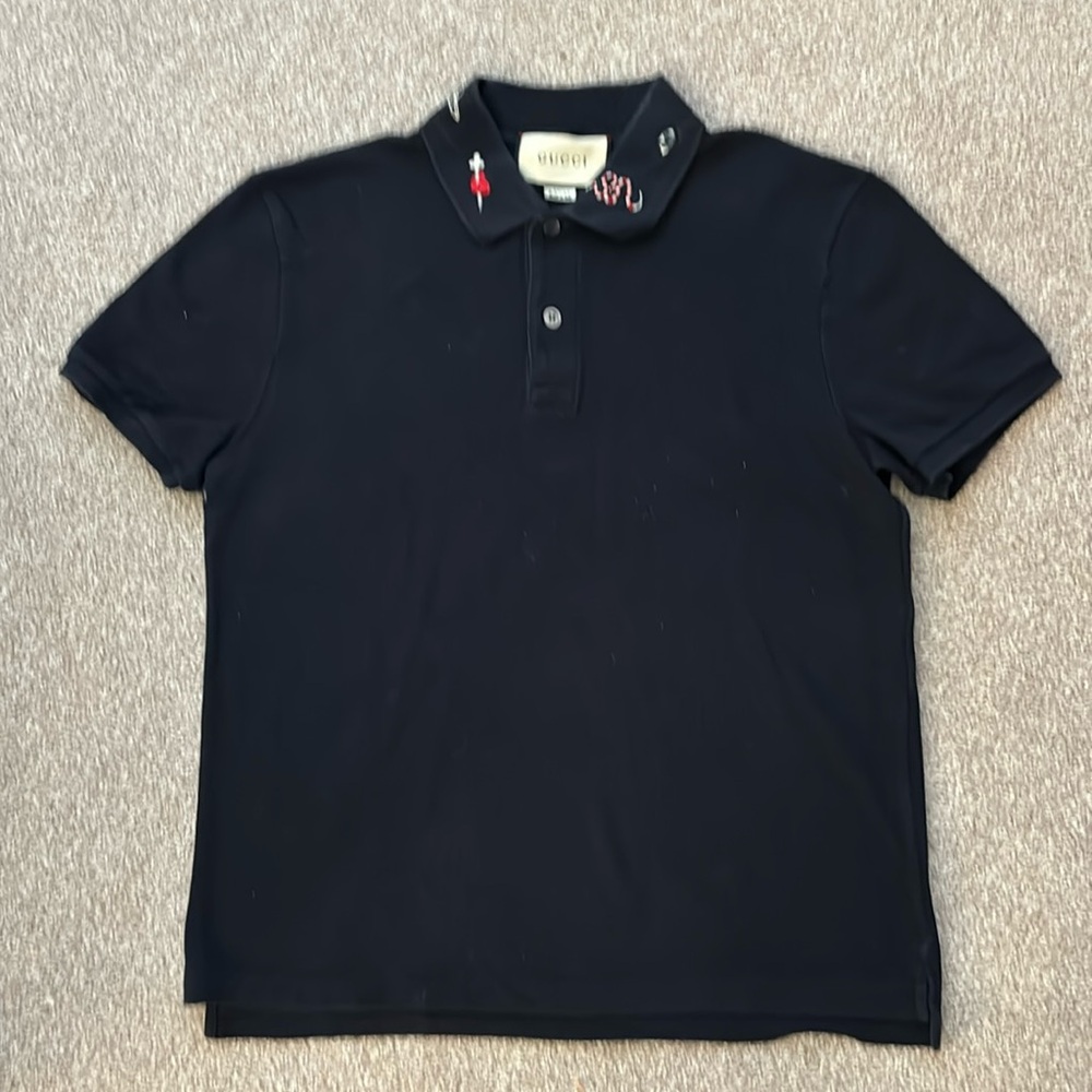 Gucci men’s polo shirt with small snake, bee crown, etc. emboidered figures.